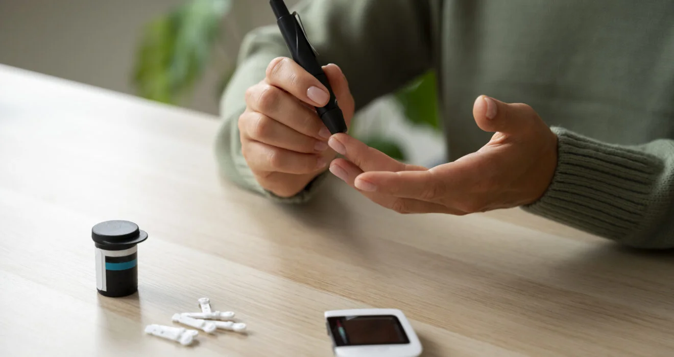 Woman monitoring blood sugar level with glucometer